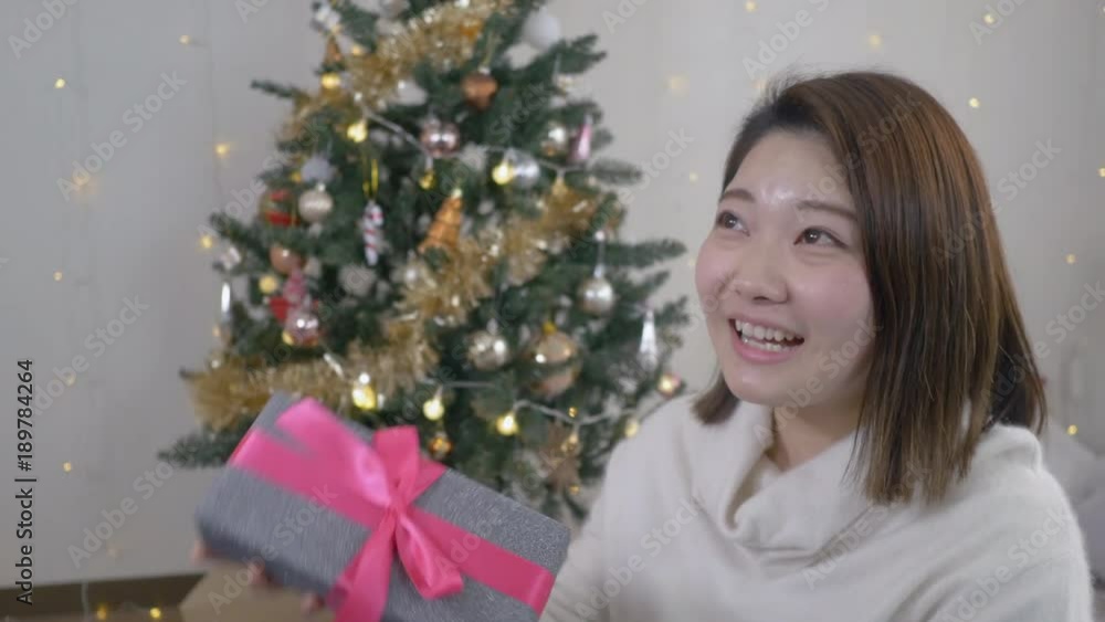 Young Japanese woman happy to get Christmas present. Young Japanese woman happy to get Christmas present.