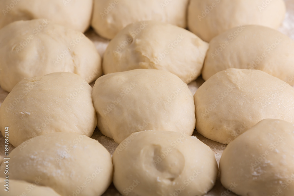 Ball-shaped pieces of dough prepared for baking pies Ball-shaped pieces of dough prepared for baking pies