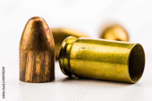 a cartridge case and projectiles lie on a table
 photo