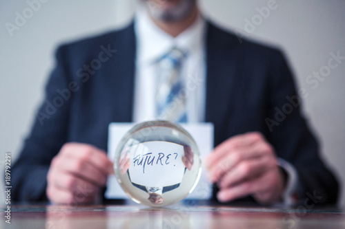 Canvastavla man holding paper with the word Future in front of glass ball