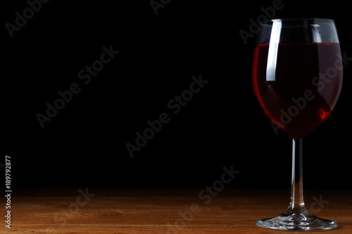 A glass of red wine on a black background, isolate