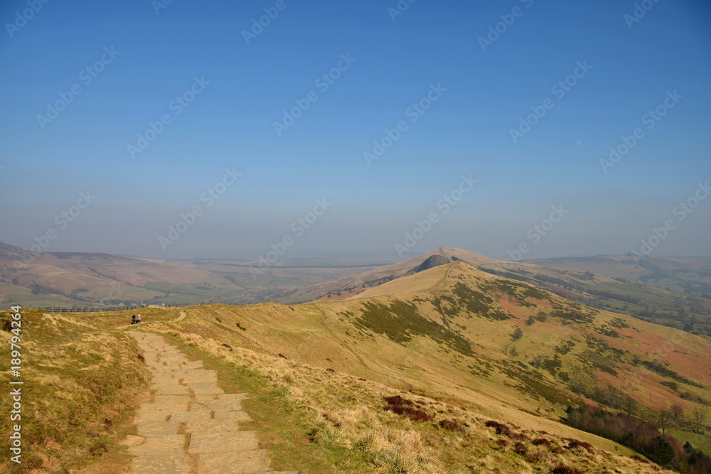 A hiking trail along the ridge of Mam Tor Mountain the beautiful Peak District countryside near Castleton, Derbyshire