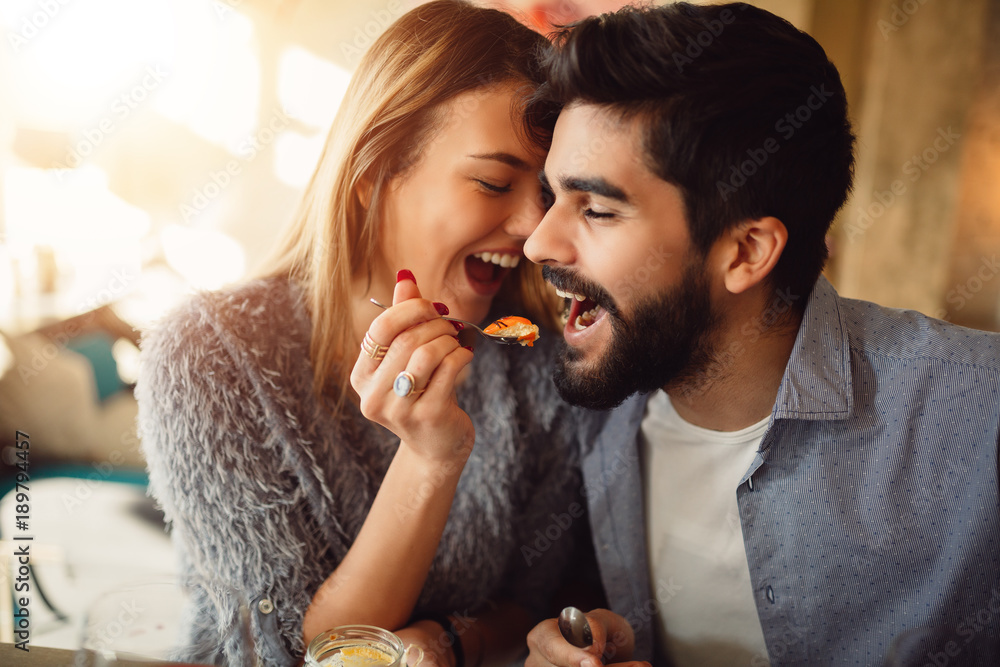 Close-up of a romantic young couple while girl feeding her boyfriend. Close-up of a romantic young couple while girl feeding her boyfriend.