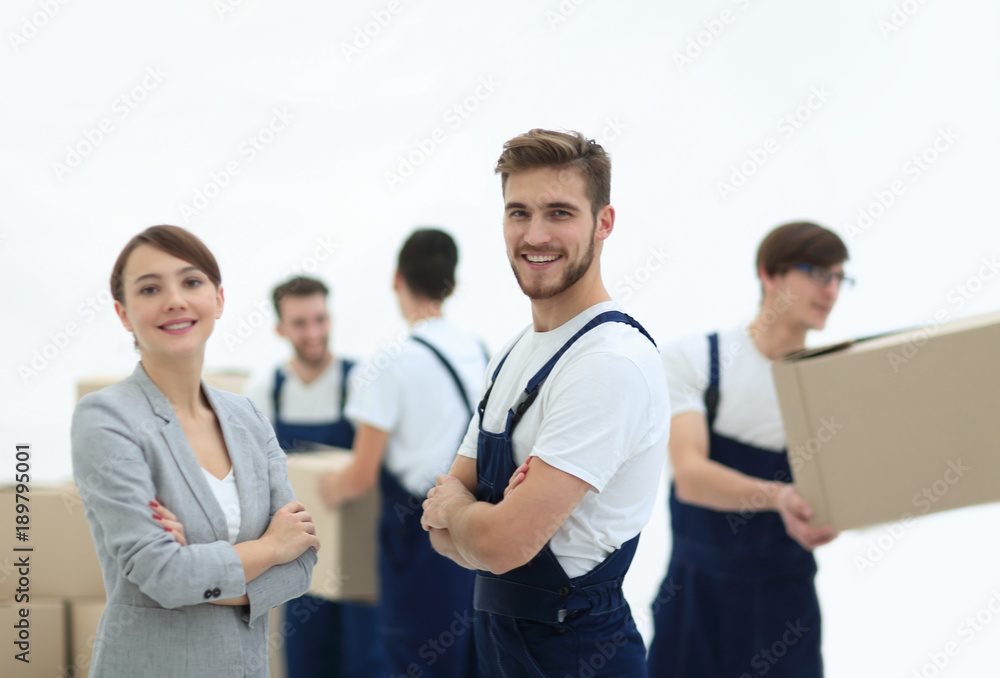 Young business woman cooperates with the team of movers. Young business woman cooperates with the team of movers.