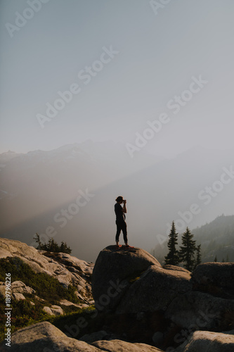 man takes pictures in the mountains