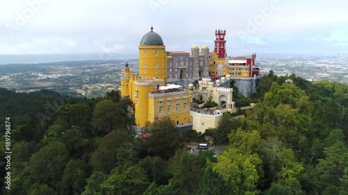Aerial view of the iconic Pena National Palace moving towards building originally built on Monastery of Nossa Senhora da Pena and renovated extensively through initiative of Ferdinand II of Portugal