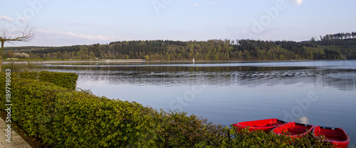 Fototapeta Naklejka Na Ścianę i Meble -  Calm lake with three red rowboats