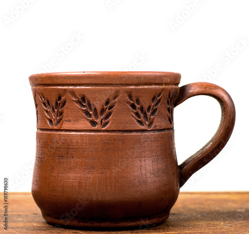 clay cup and saucer clay cup and saucer on a white wooden background