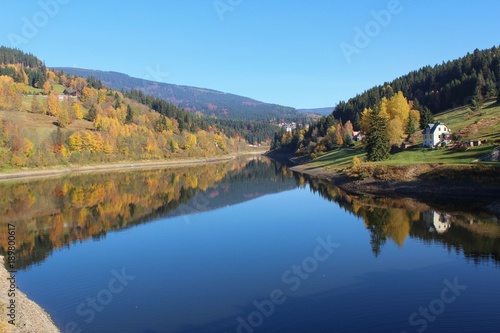 Autumn landscape view with pond in Spindleruv Mlyn, Czech Republic
