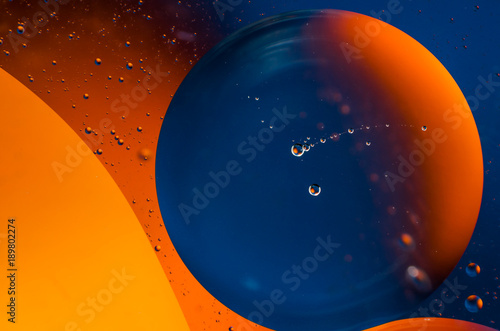 Oil drops on water surface abstract background