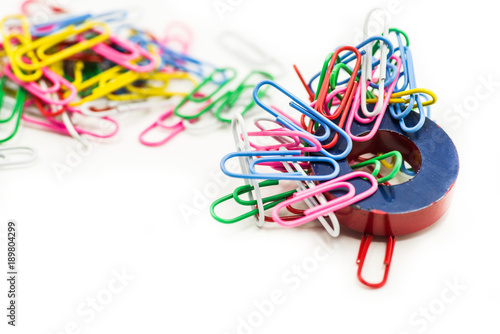 Magnet and paper clips isolated on a white background.