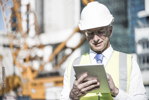 Construction manager controlling building site and tablet device