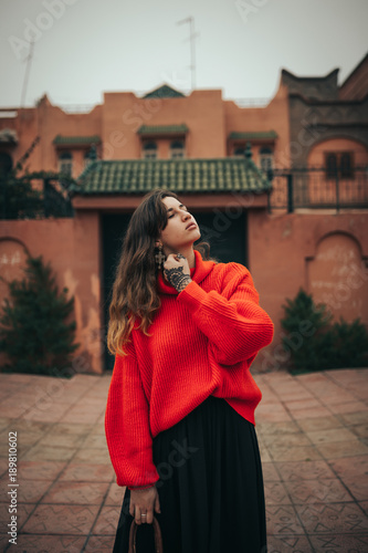 Young woman with red wool pullover and bag © Juanje Garrido