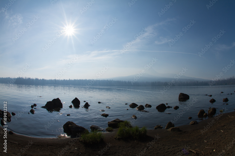 Naklejka premium Rocks on the shoreline of Big Lake in Oregon Deschutes National Forest on a sunny summer day..