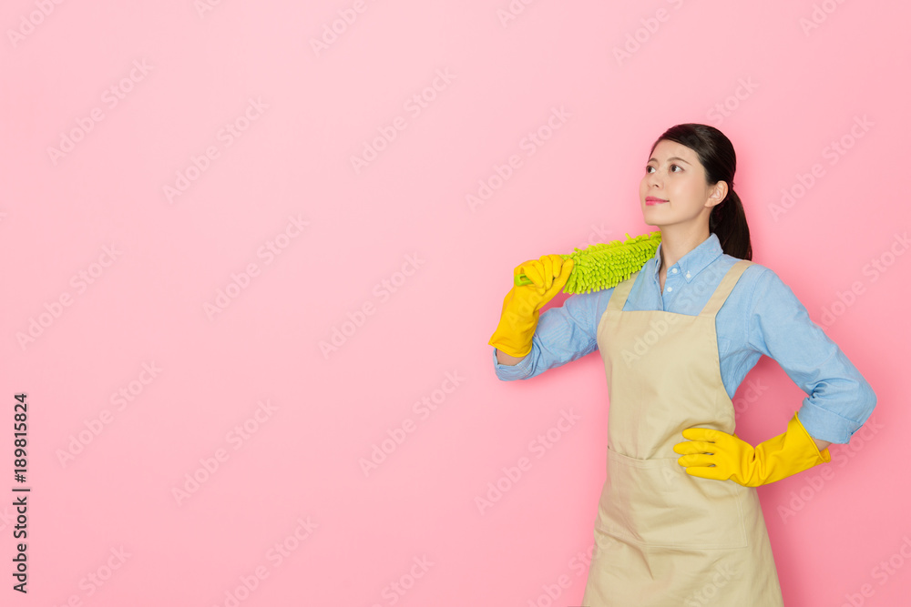 smiling woman housekeeper carrying feather duster smiling woman housekeeper carrying feather duster