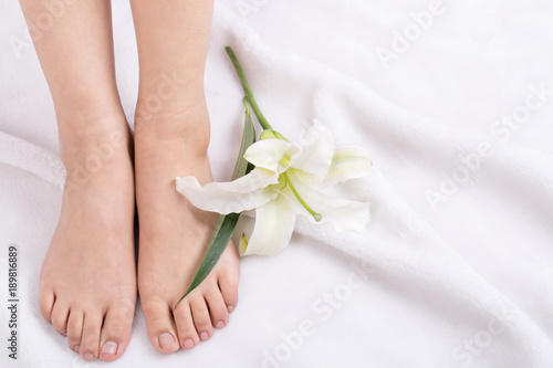Woman's feet and lily flower, indoor.
