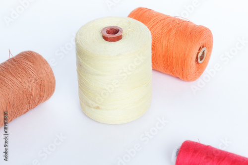 Obraz na plátne Four reels of colored thread on a white background