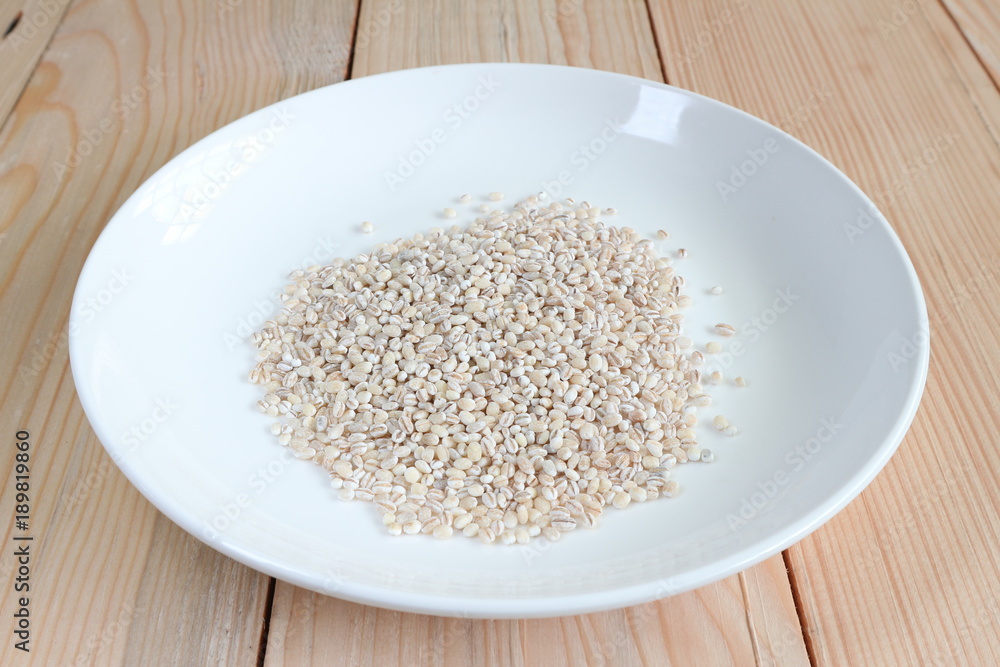 Close up cereal soy bean on white plate with wood plate background. Close up cereal soy bean on white plate with wood plate background.