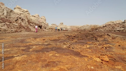 ETHIOPIA,DALLOL-CIRCA  DECEMBER 2017--unidentified people walking in the volcanic depression and salt hill photo