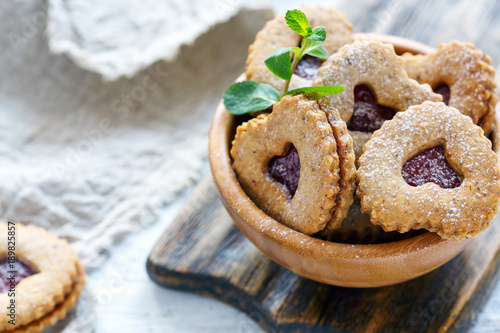 Cookies in the form of hearts in a wooden bowl.