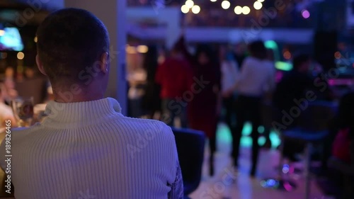 the man in the club sits