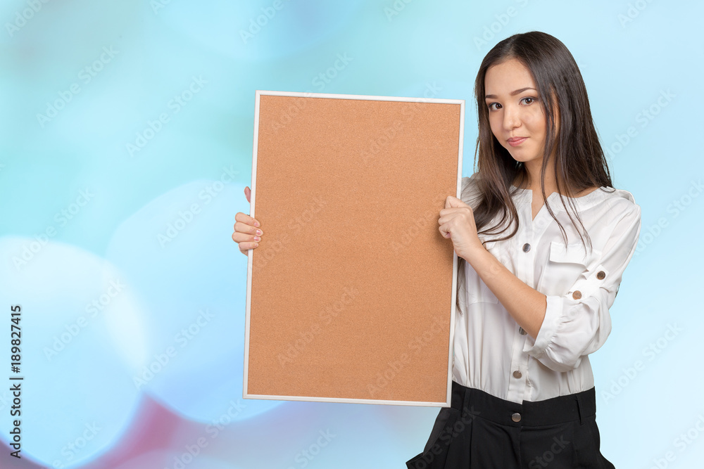 Smiling casual woman holding the empty corkboard Smiling casual woman holding the empty corkboard