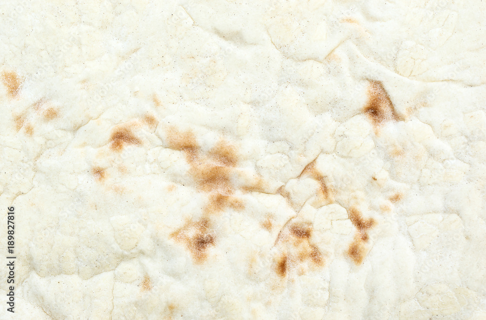 The texture of baked thin flatbread. Macro photo.