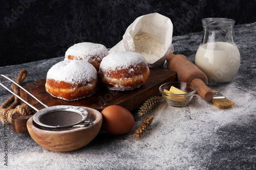 german donuts or berliner with ingredient on grey background