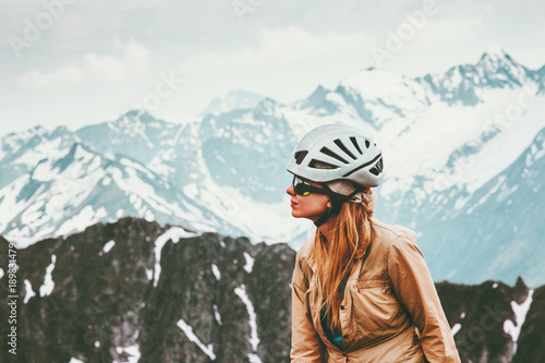 Woman climber in mountains with helmet gear Travel Lifestyle adventure concept active extreme vacations outdoor mountaineering sport © EVERST