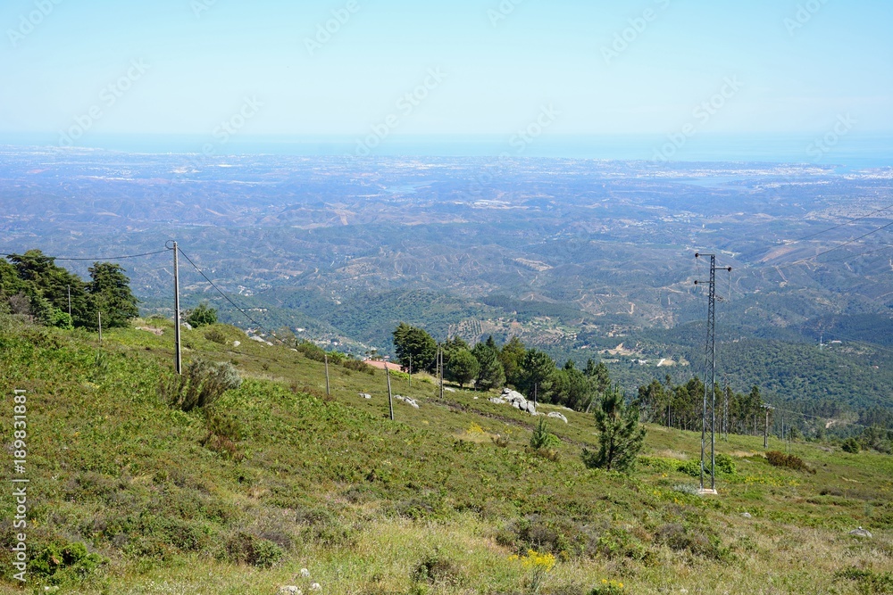Elevated view across the Monchique mountains and countryside towards the coastline, Algarve, Portugal.