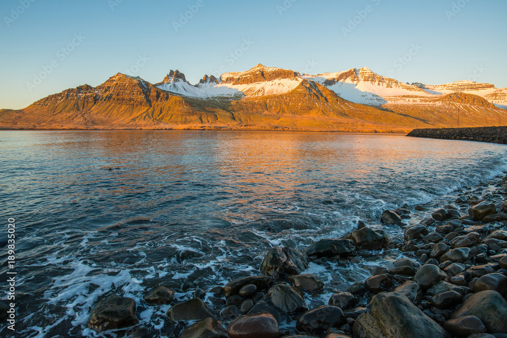 Beautiful mountains range in Stoovarfjorour the fisherman village in east fjord of east Iceland during the sunrise.