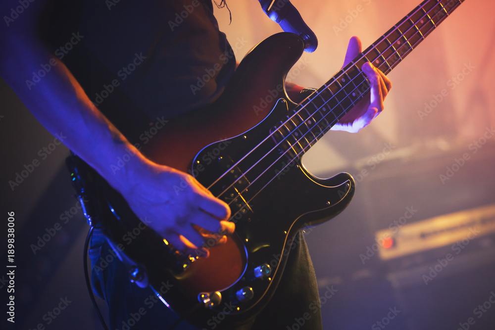 Electric bass guitar player, close up photo - obrazy, fototapety, plakaty 