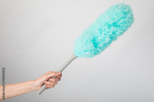 Hand holding a microfiber feather duster. photo