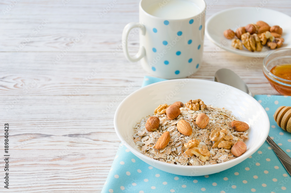 Healthy breakfast of muesli with nuts, honey and milk Healthy breakfast of muesli with nuts, honey and milk