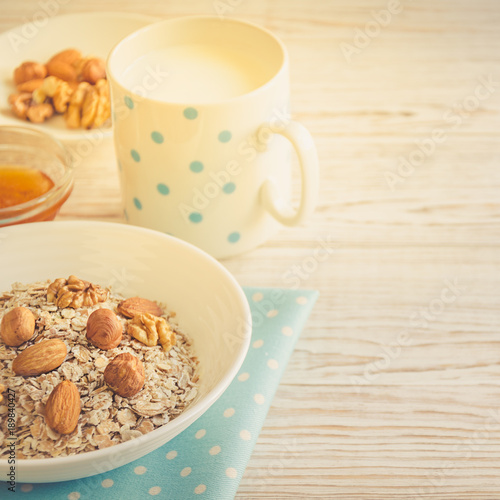 Healthy breakfast of muesli with nuts, honey and milk
