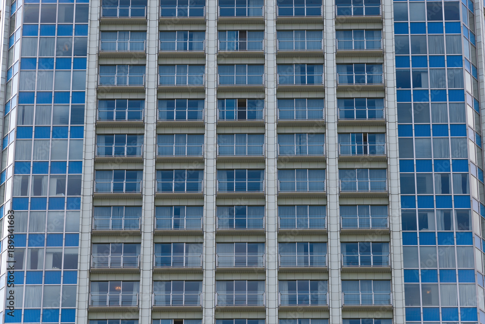 The blue windows of the building, background texture pattern of the windows. The blue windows of the building, background texture pattern of the windows.