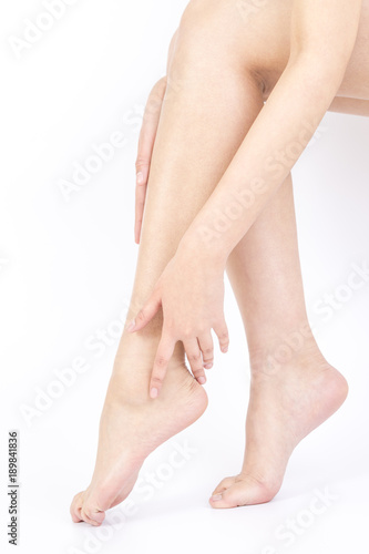 Woman touching her heel  white background  