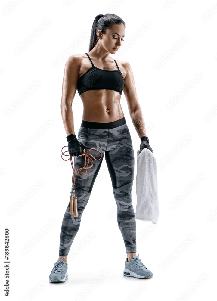 Fitness woman is sweaty. Sporty woman with skipping rope and towel in hands. Resting time. Fitness woman is sweaty. Sporty woman with skipping rope and towel in hands. Resting time.