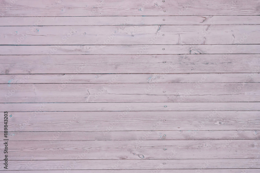 The whole texture of the old wooden boards with natural pattern and the remnants of the bright paint, abstract grunge retro background The whole texture of the old wooden boards with natural pattern and the remnants of the bright paint, abstract grunge retro background
