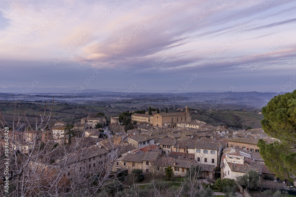 Aerial view of San Gimignano and the Church of Sant'Agostino at sunset, Siena, Tuscany, Italy