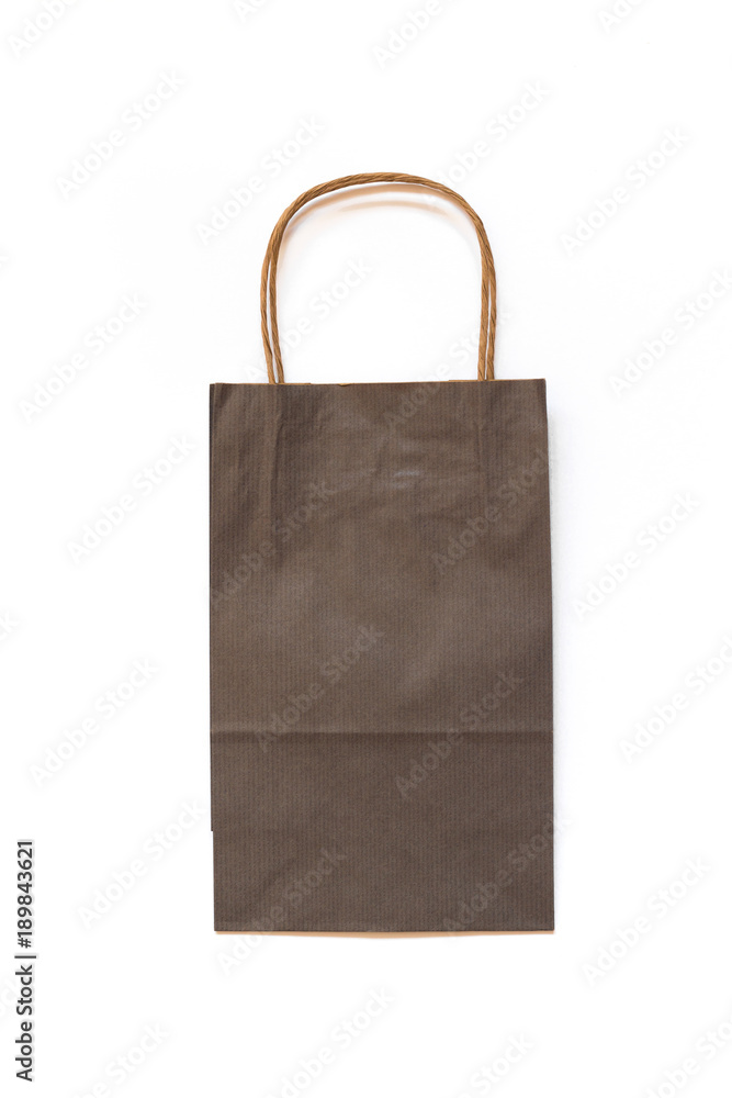 Gray paper bag on white background. Mockup. Concept of shopping. Gray paper bag on white background. Mockup. Concept of shopping.