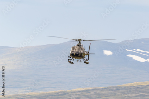 Fototapeta Naklejka Na Ścianę i Meble -  Helicopter in the sky in a wild mountain landscape