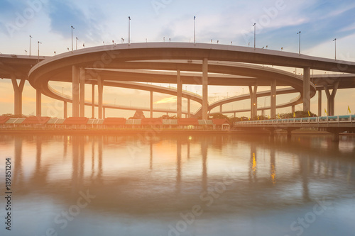 Highway intersection river front with sunset sky background © pranodhm