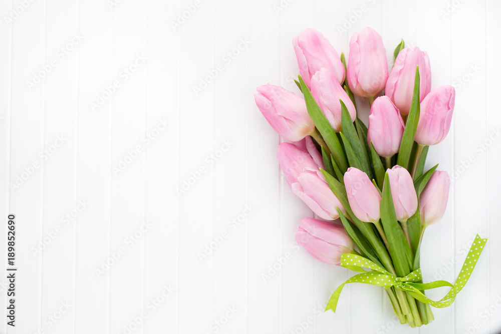 Fresh red tulip flowers bouquet on shelf in front of wooden wall. Fresh red tulip flowers bouquet on shelf in front of wooden wall.