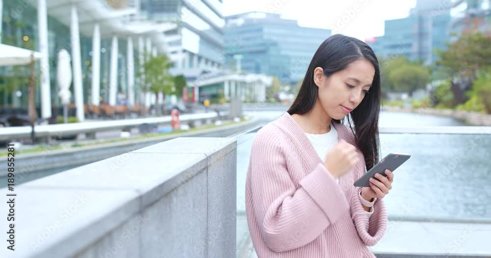 Woman looking at mobile phone at outdoor Woman looking at mobile phone at outdoor