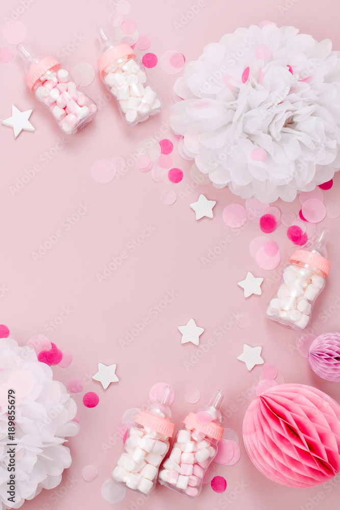Frame made of Decorative Baby milk bottles with candy and paper decorations for Baby shower party. Flat lay, top view Frame made of Decorative Baby milk bottles with candy and paper decorations for Baby shower party. Flat lay, top view