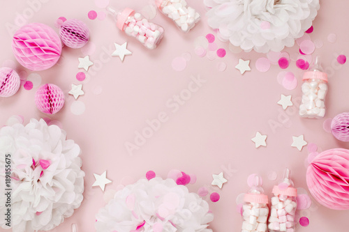 Frame made of Decorative Baby milk bottles with candy and paper decorations for Baby shower party. Flat lay, top view
