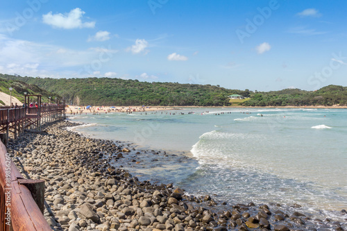 Boardwalk and beach with tide coming in on a hot summer's day. Beach fun background photo