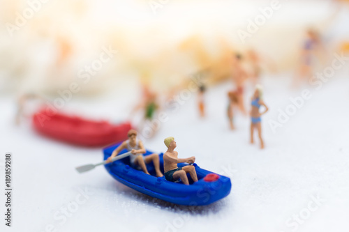 Miniature people : Travelers with paddle boat . Image use for activities, travel business concept.
