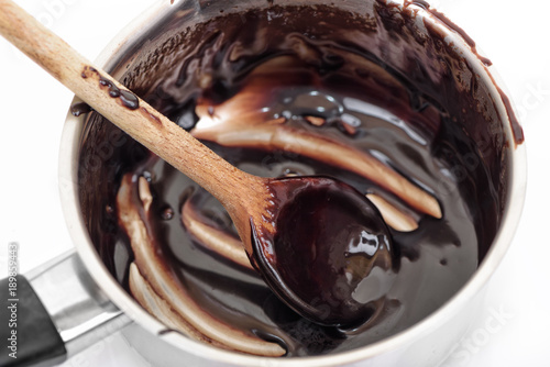 Preparing chocolate frosting in pan. Top view. photo